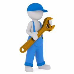 Male mini worker in blue with big wrench